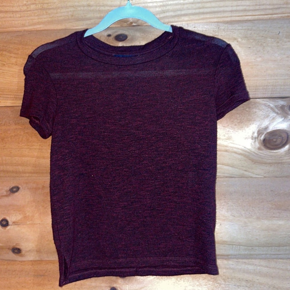 Maroon and black short sleeved shirt.